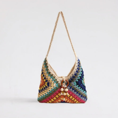 Handmade macrame shoulder bag with playful pendant Skanto