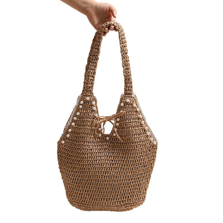 Handbag with pearl embellishments and innovative closure Skanto