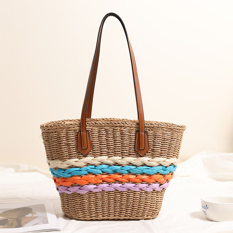 Basket-style straw bag with colorful braided accents Skanto