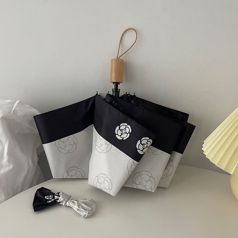 Dame elegant paraply med stilfullt blomsterdesign Skanto