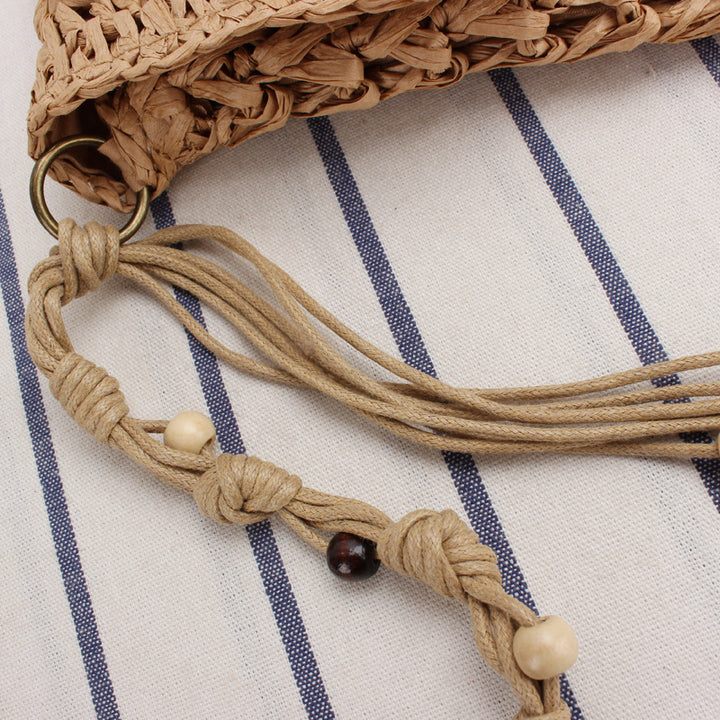 Woven natural material handbag with playful fringes Skanto