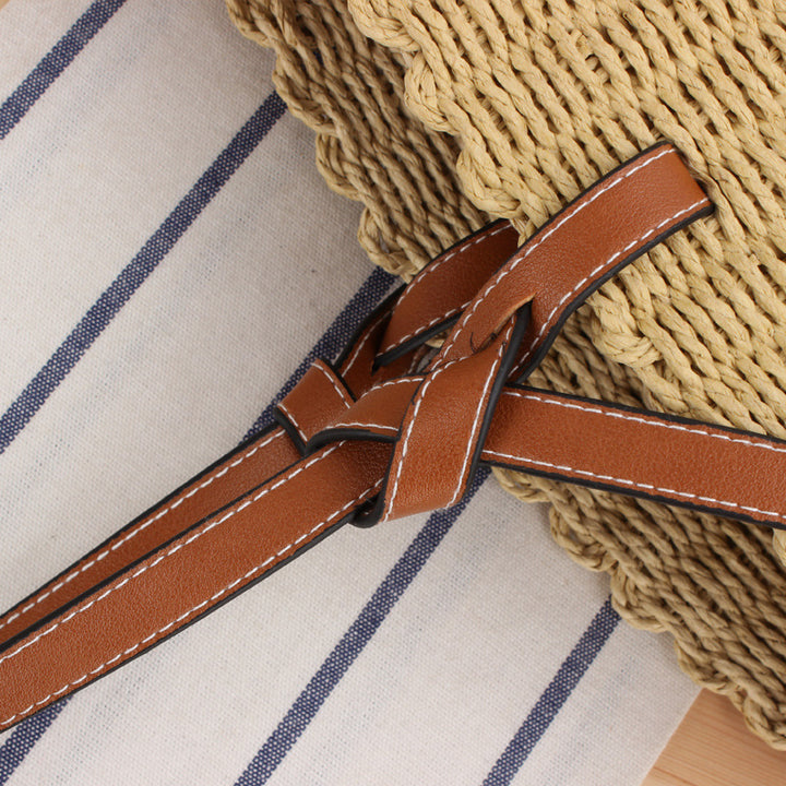 Woven natural material handbag with elegant leather handles Skanto