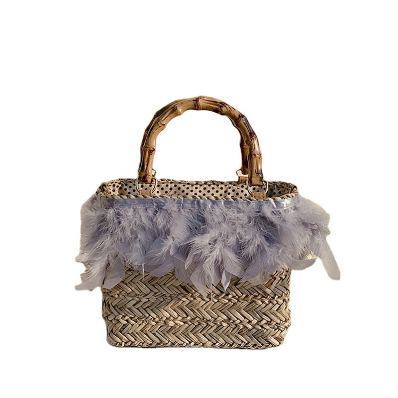 Elegant handbag with feathers and bamboo handle Skanto