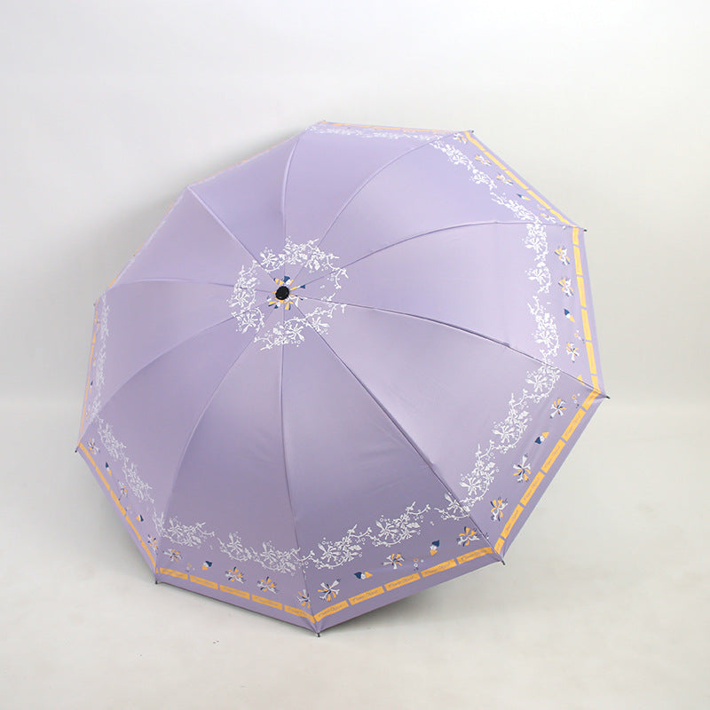 Kvinnens elegante sammenleggbare paraply med blomsterdesign Skanto