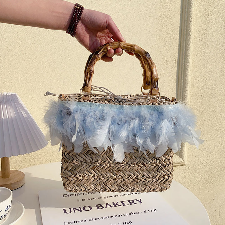 Elegant handbag with feathers and bamboo handle Skanto