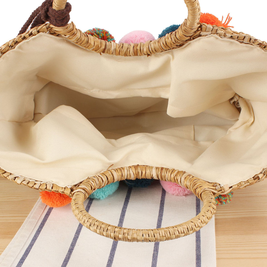 Straw handbag with colorful tassels and pom poms Skanto