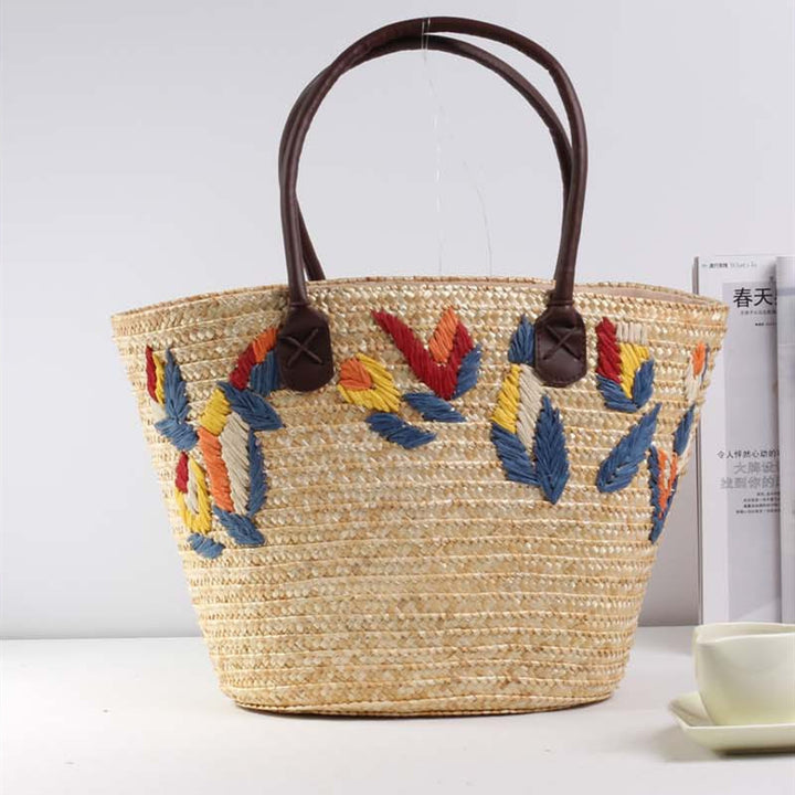Braided beach bag with colorful embroidery pattern Skanto