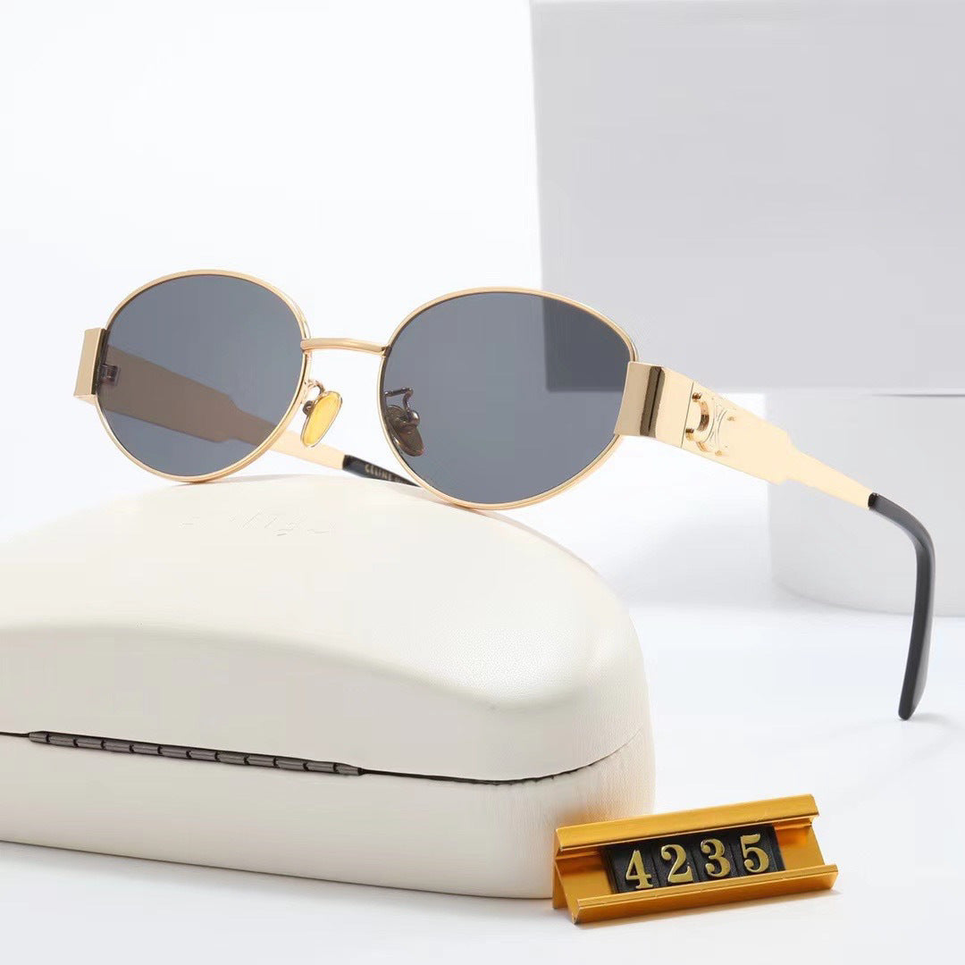 Dame elegant oval solbrille med gullfarget ramme Skanto