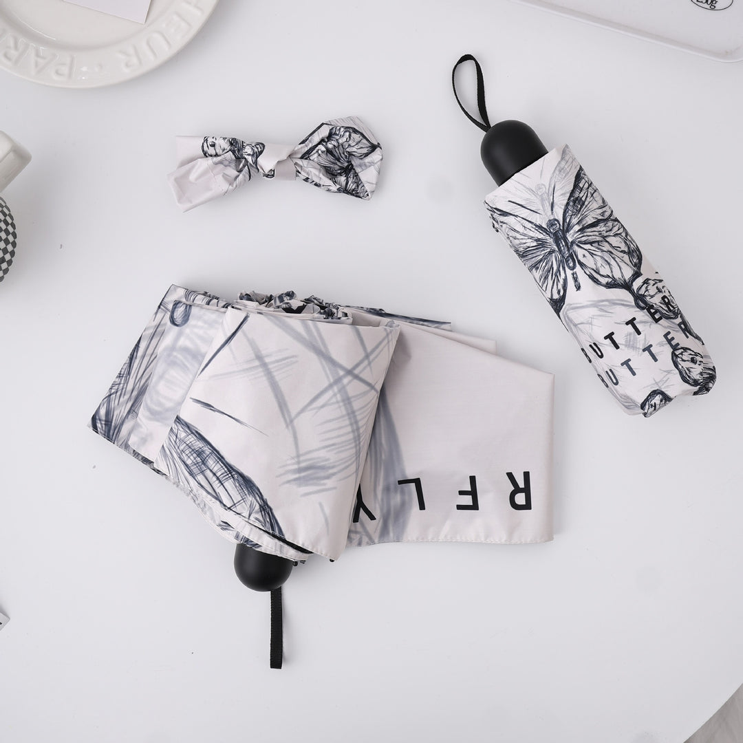 Dame fashionable foldeparaply med leken design Skanto