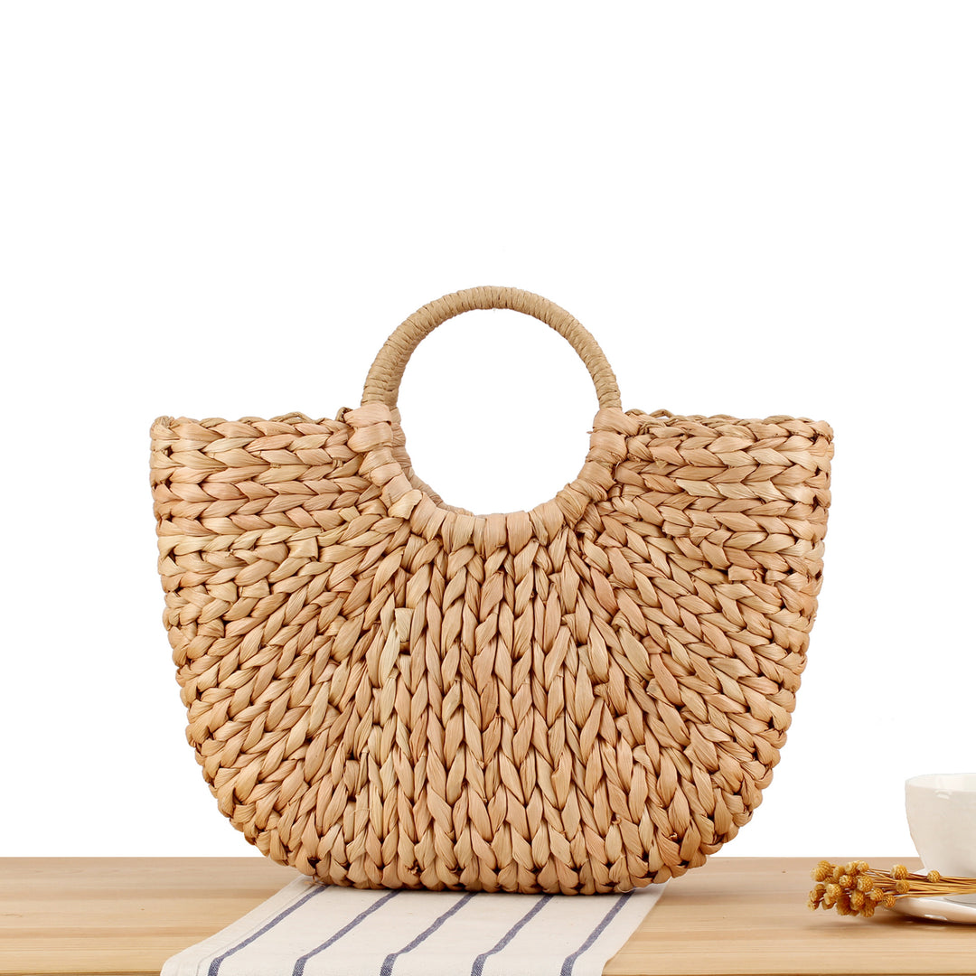 Woven natural material handbag with elegant round handle Skanto
