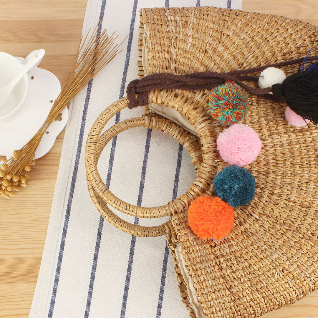 Straw handbag with colorful tassels and pom poms Skanto
