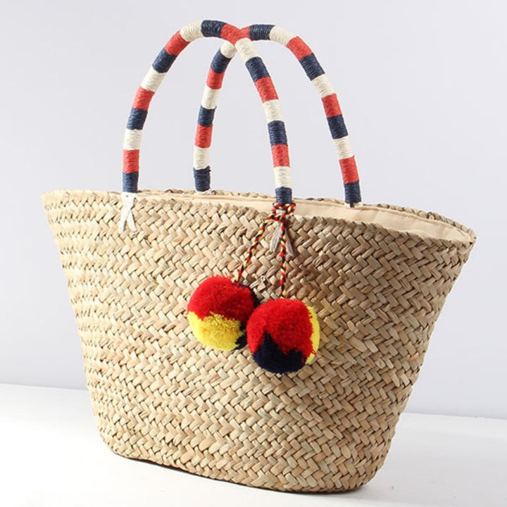 Braided beach bag with decorative pom-poms Skanto