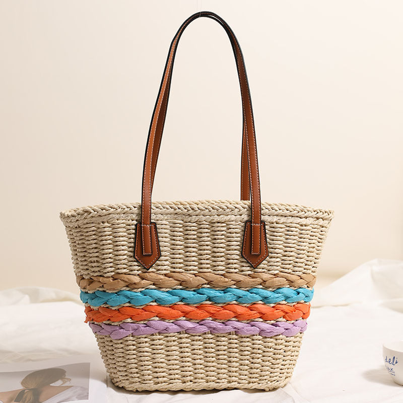 Basket-style straw bag with colorful braided accents Skanto