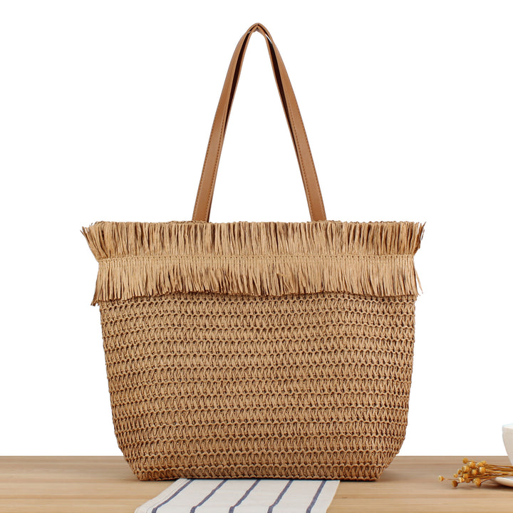 Beach bag made of hand-woven natural material with fringe detail Skanto