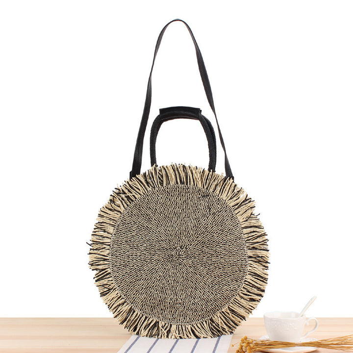 Round bag with fringe detail Made of braided material Skanto