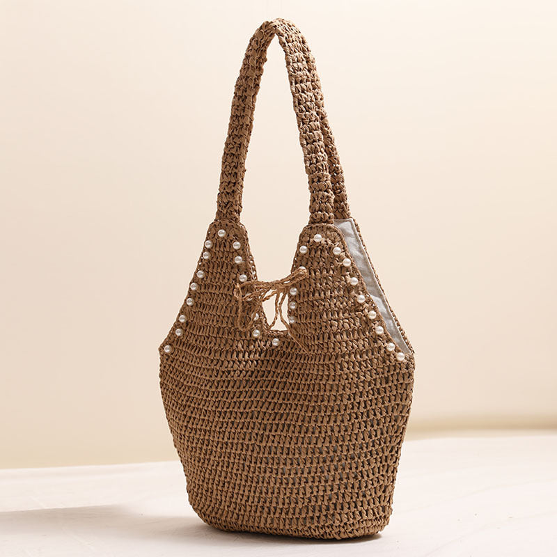 Handbag with pearl embellishments and innovative closure Skanto