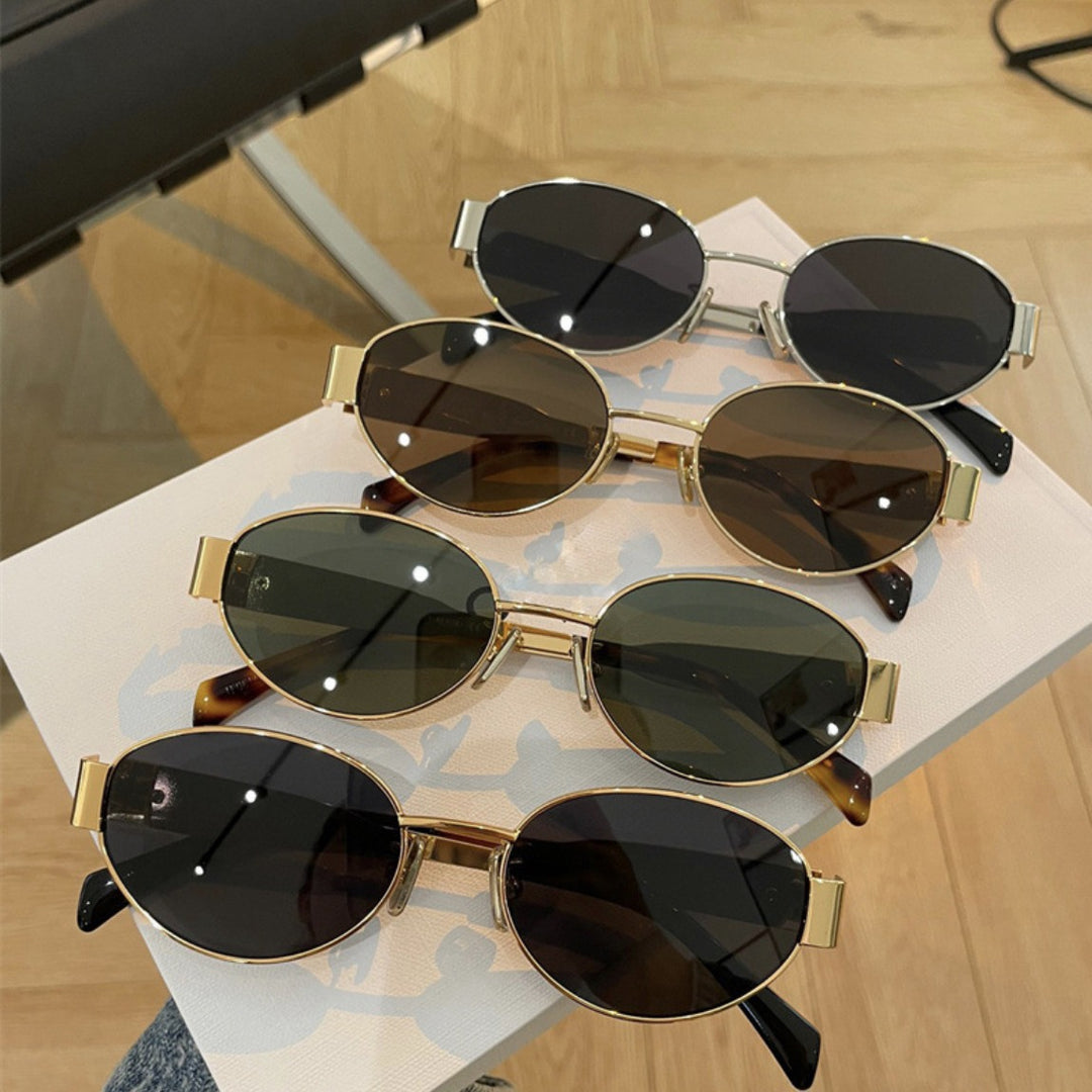 Dame elegant oval solbrille med gullfarget ramme Skanto
