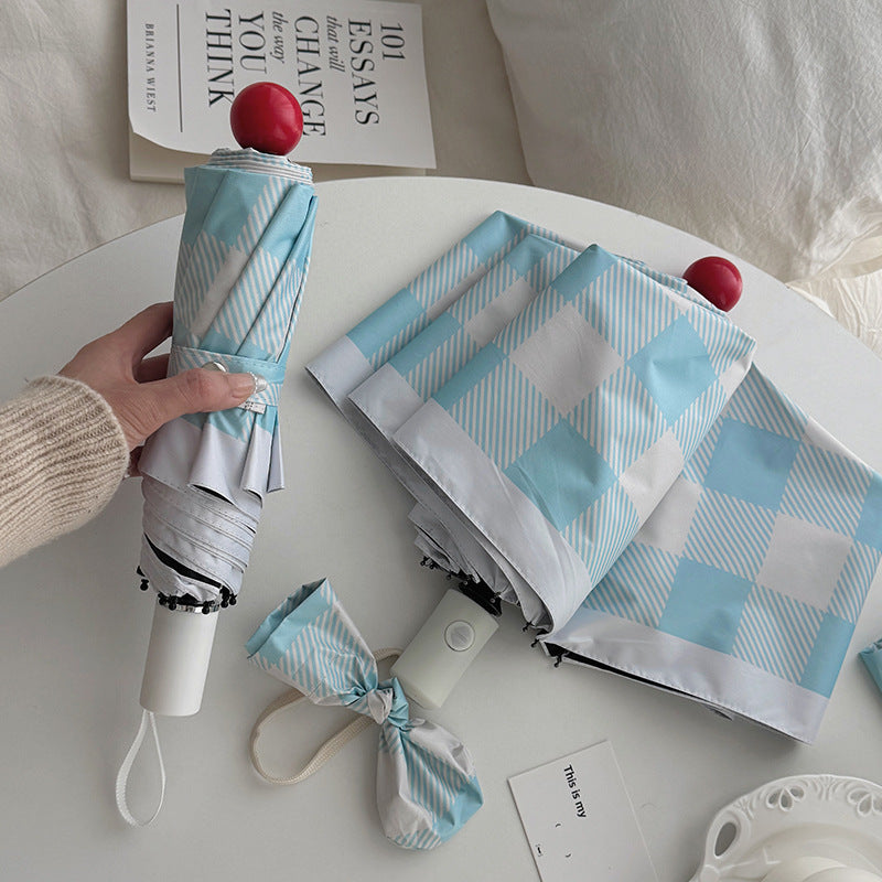 Dame sammenleggbart paraply med spesiell design Skanto