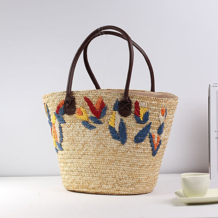 Braided beach bag with colorful embroidery pattern Skanto