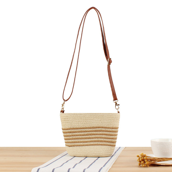 Crossbody bag made of braided natural material with contrasting stripes Skanto