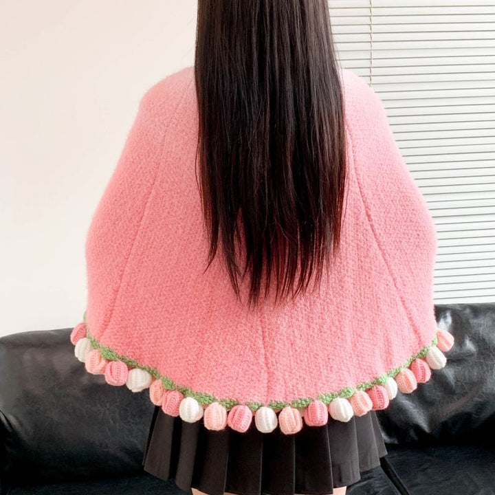 Poncho med fargerik pompongdetalj Skanto