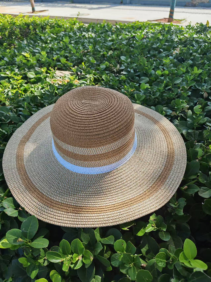 Elegante solhatt med bred brem og diskret stripemønster Skanto