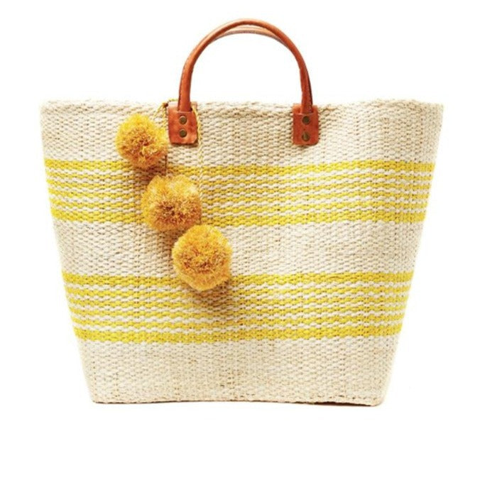 Stylish straw bag with playful pom-poms Skanto