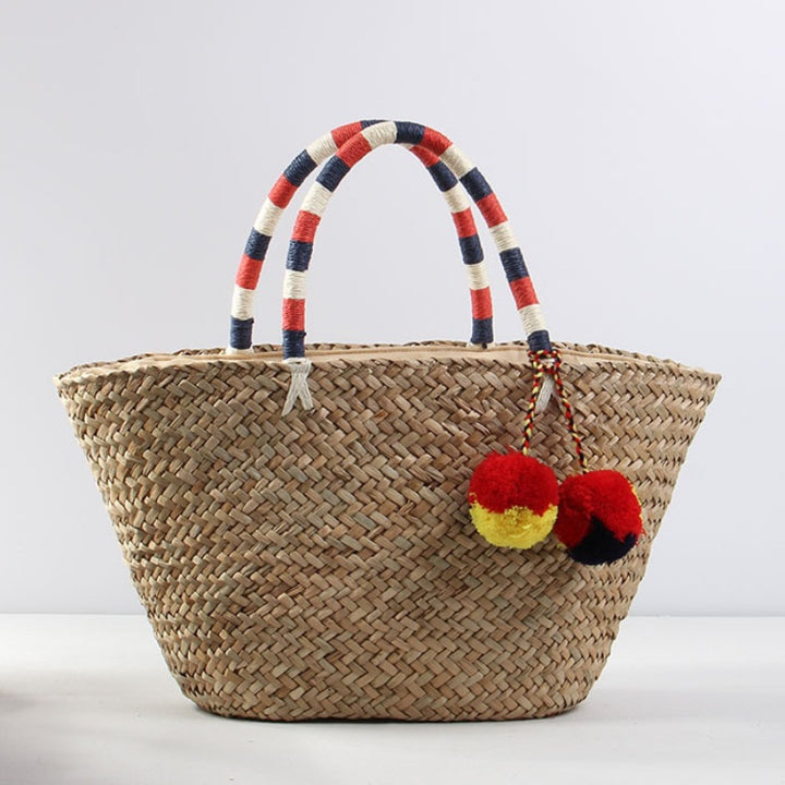 Braided beach bag with decorative pom-poms Skanto