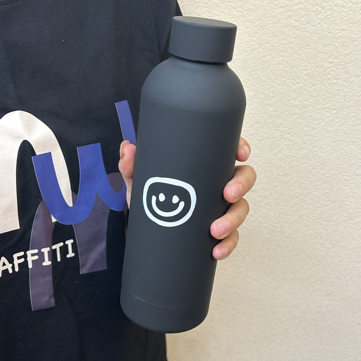 Dame isolasjonsflaske med glad smiley-design Skanto