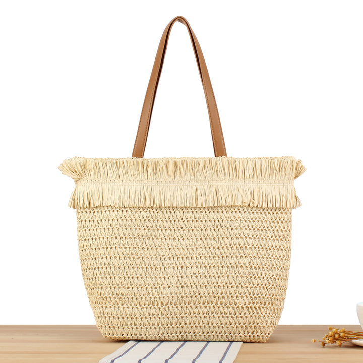 Beach bag made of hand-woven natural material with fringe detail Skanto