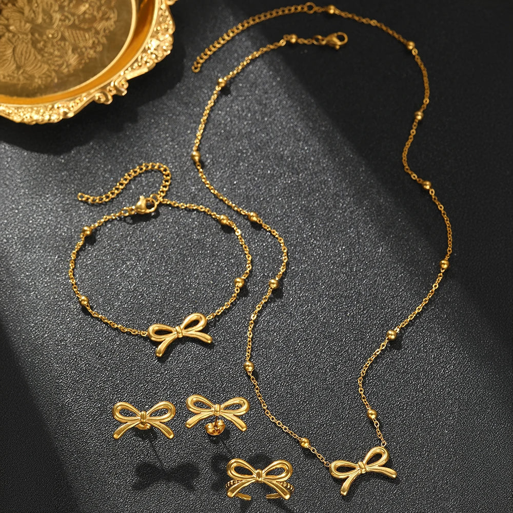 Skanto | Feminine Bow Satellite Chain Necklace, Bracelet, Earrings, and Ring Set