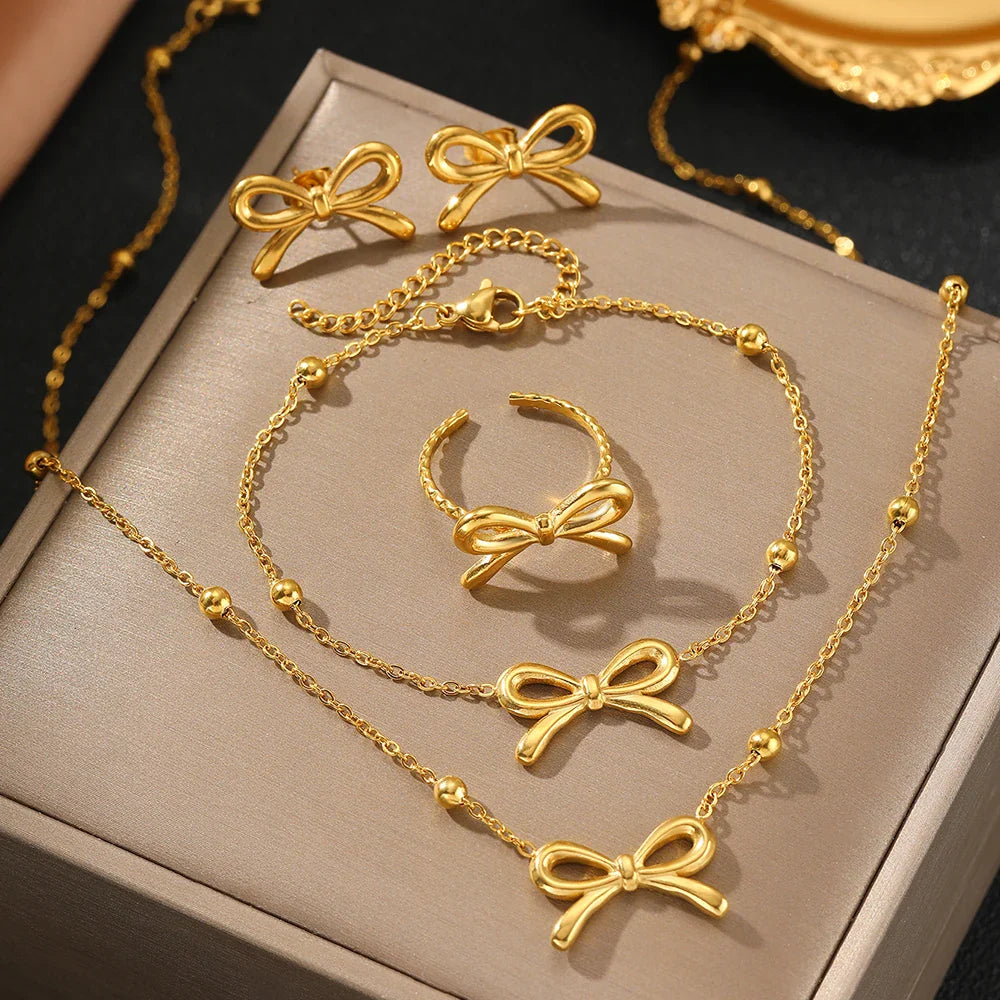 Skanto | Feminine Bow Satellite Chain Necklace, Bracelet, Earrings, and Ring Set
