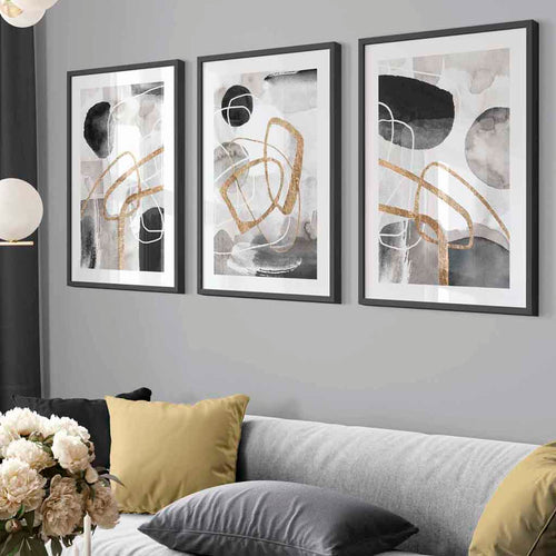 Abstrakte former i svart, grått og gull, sett med 3 innrammede veggkunstverk