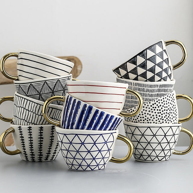 Skanto | Cup med abstrakt geometrisk mønster og gullhåndtak