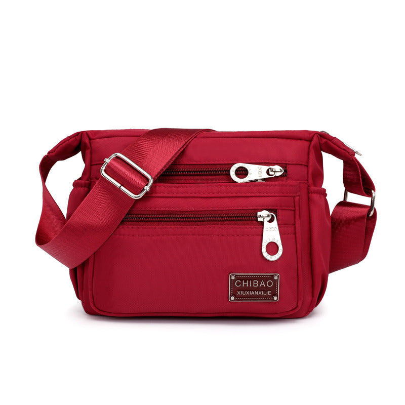 Skanto | Kvinners Multi-lags Nylon Crossbody Bag